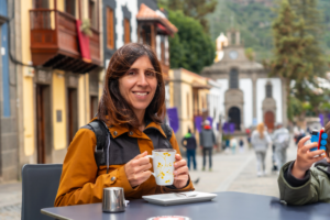 a tourist woman resting and having a coffee - Altitude in Cusco: How to Prepare and Enjoy Your Trip