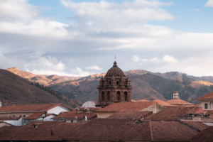 church tower emerging from cusco rooftops - Altitude in Cusco: How to Prepare and Enjoy Your Trip