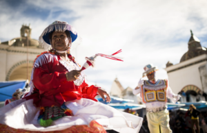 woman dancing in bright costume at urban event - The Definitive Seasonal Guide: When is the Best Time to Visit Cusco? - Columbus Ecuador