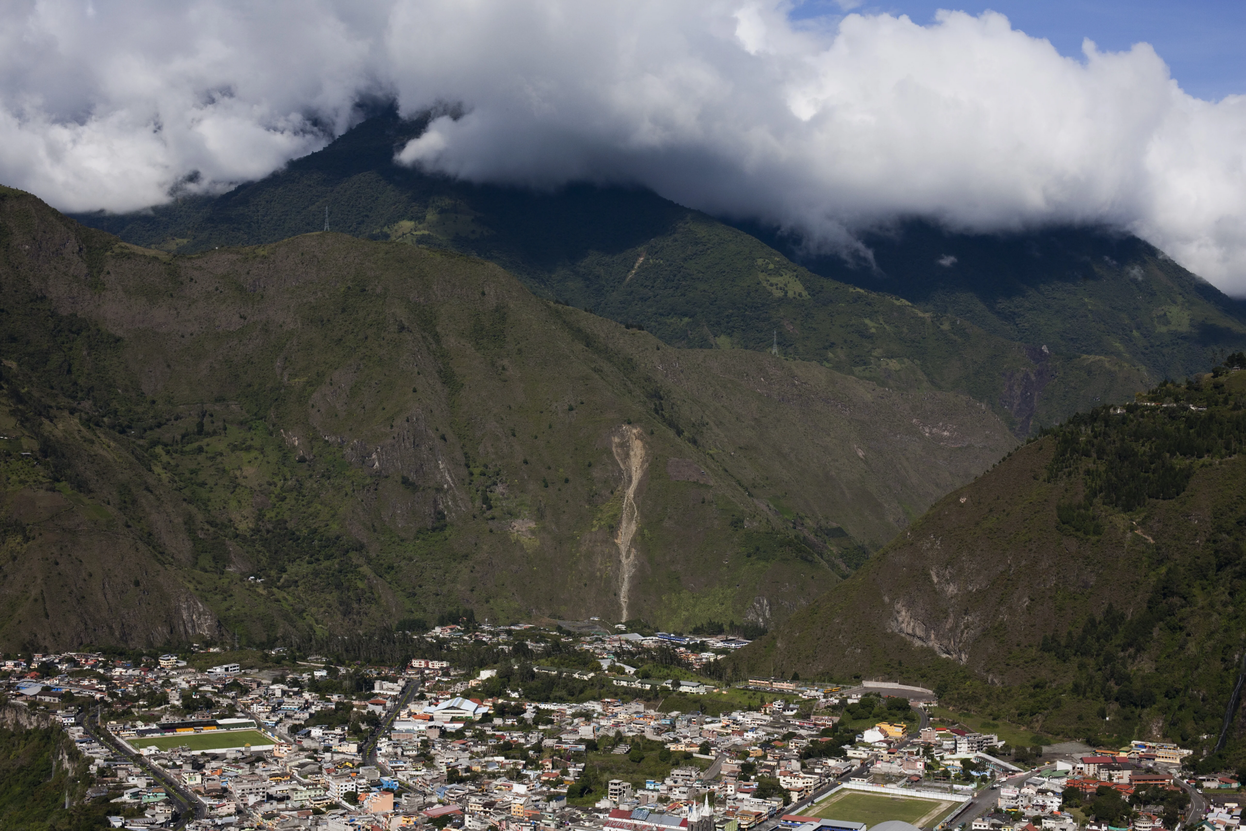 view of mountains and distant cityscape banos ecuador - How to Travel from Quito to Baños: The Ultimate Gateway to the Amazon