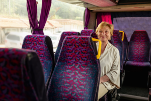 woman smiling on a passenger quito to baños